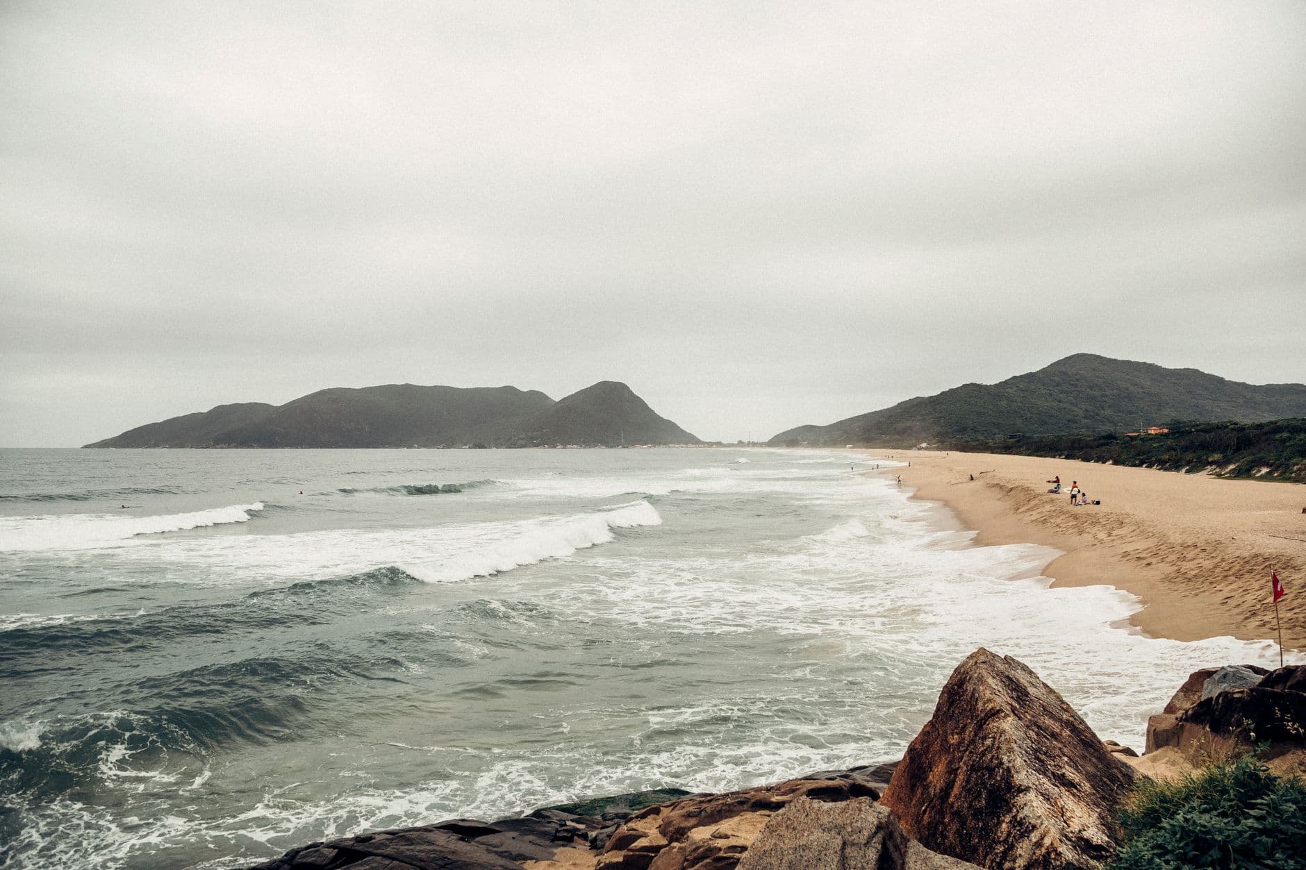 A picturesque view of the beach and ocean waves at Florianópolis, Brazil, offering a serene coastal landscape.